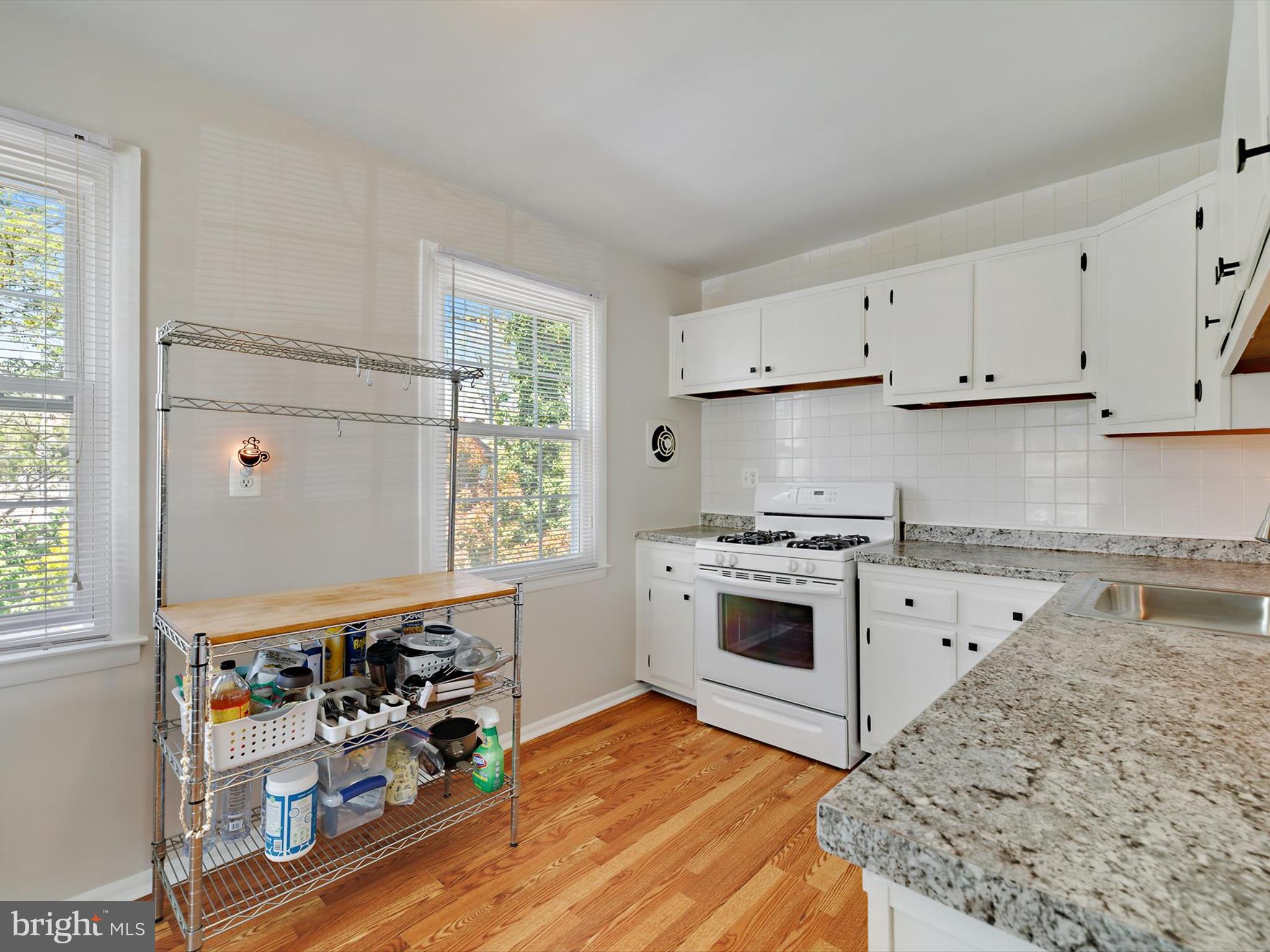 8366 Imperial Drive, Unit 2A Laurel, MD 20708 - Photo 9 of 27 a kitchen with stainless steel appliances granite countertop a stove a sink and a refrigerator