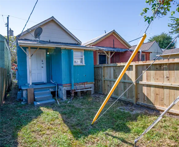 a view of a house with a wooden deck and a slide