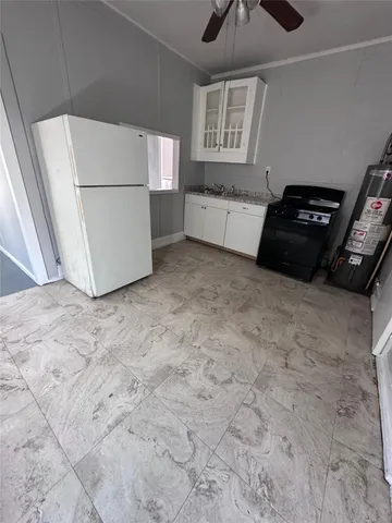 a kitchen with a refrigerator and a stove