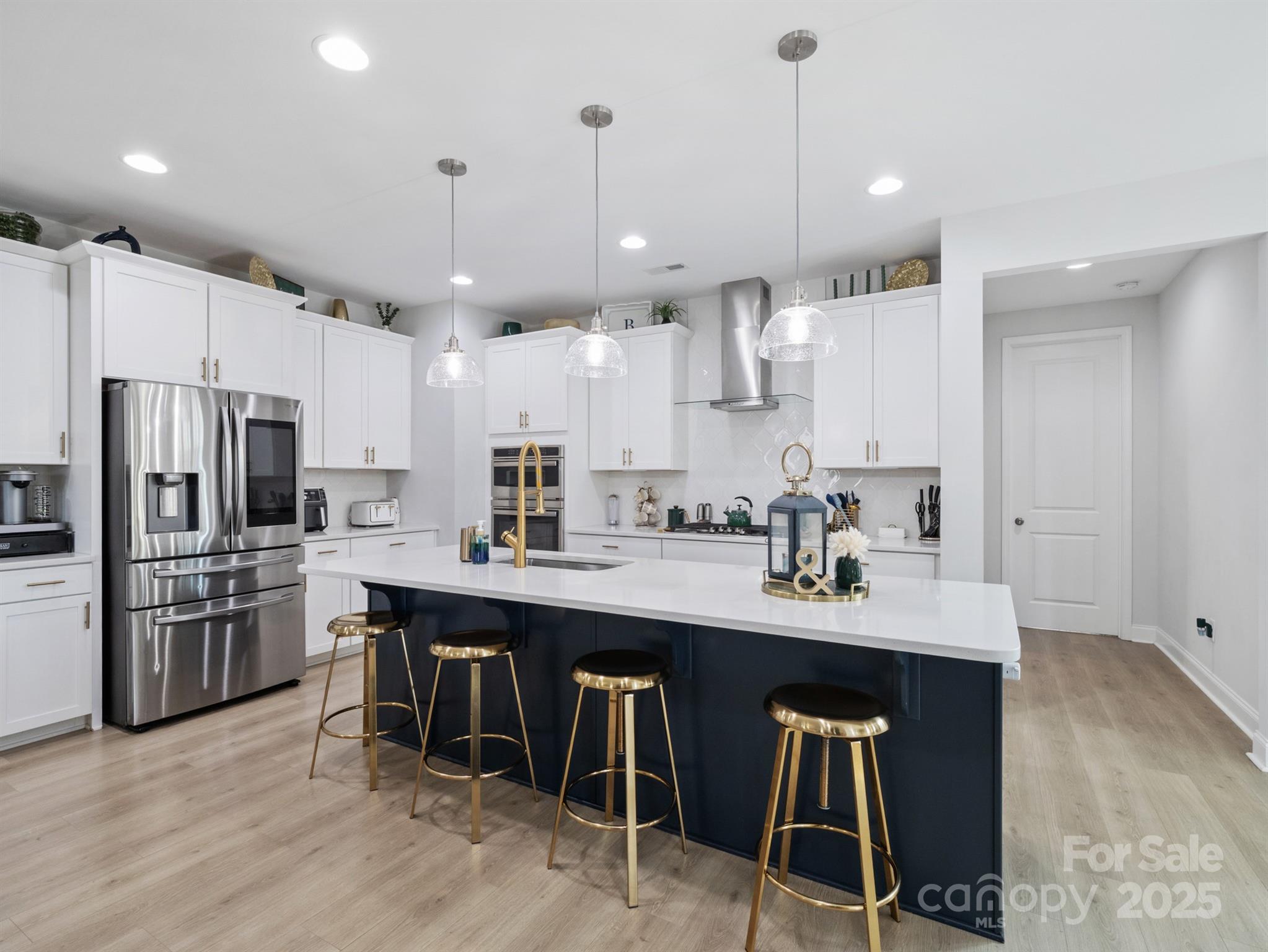 15213 Shallow Ridge Road Charlotte, NC 28278 - Photo 11 of 48 a kitchen with stainless steel appliances granite countertop a sink a stove a refrigerator and chairs