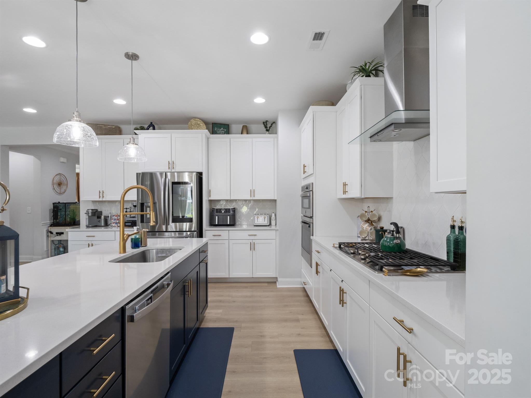 15213 Shallow Ridge Road Charlotte, NC 28278 - Photo 12 of 48 a kitchen with stainless steel appliances kitchen island granite countertop a sink and cabinets