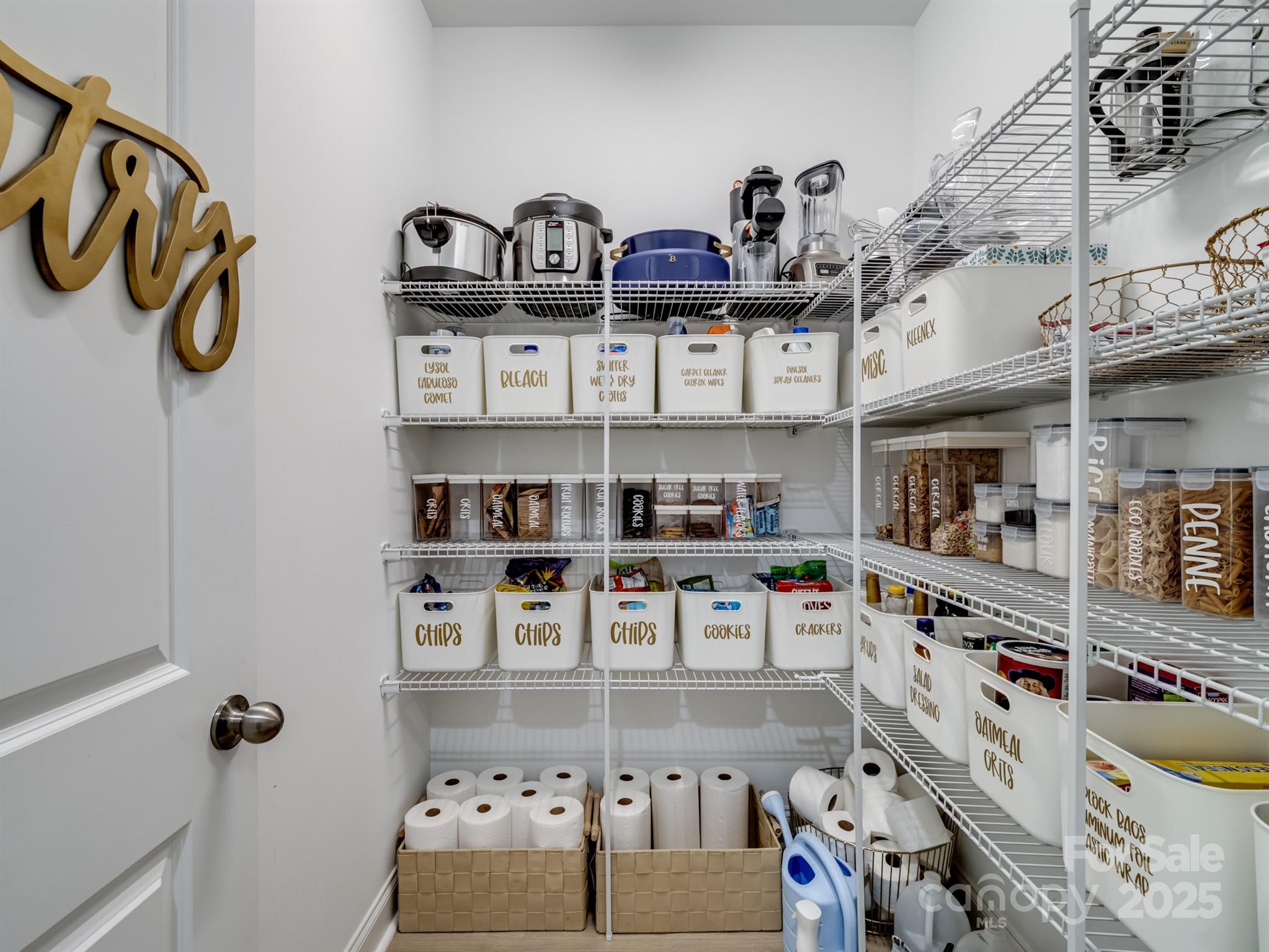 15213 Shallow Ridge Road Charlotte, NC 28278 - Photo 14 of 48 a kitchen with lots of clutter and cabinets