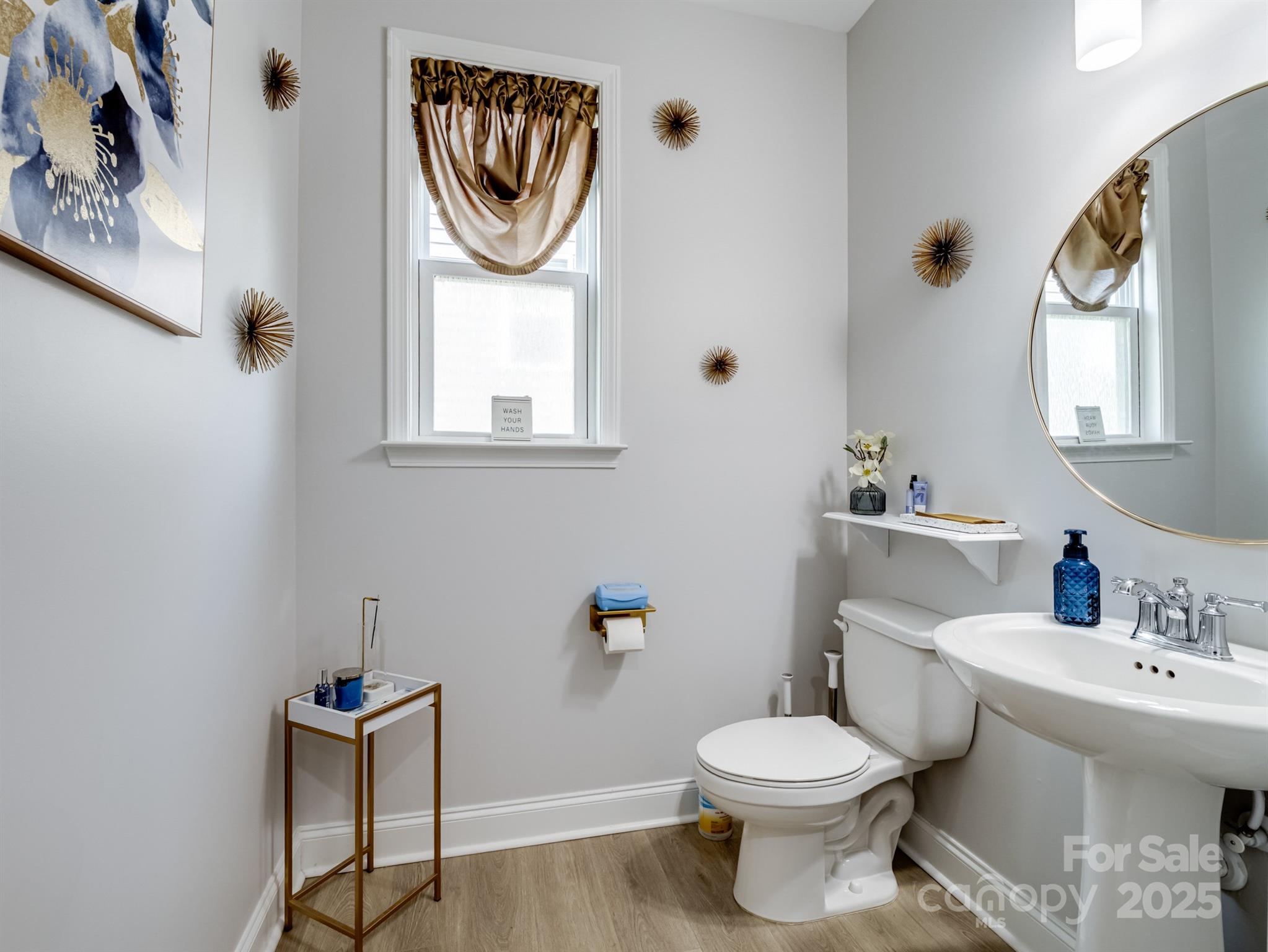 15213 Shallow Ridge Road Charlotte, NC 28278 - Photo 23 of 48 a white toilet sitting next to a bathroom sink