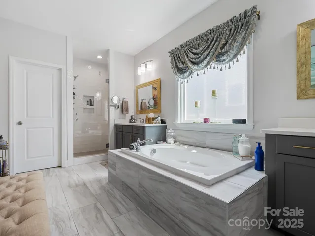 a bathroom with a sink mirror and a shower