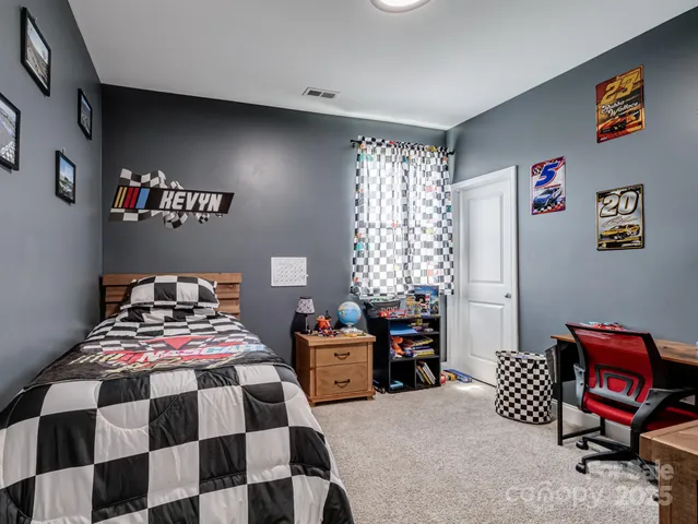 a bedroom with two beds and a chair