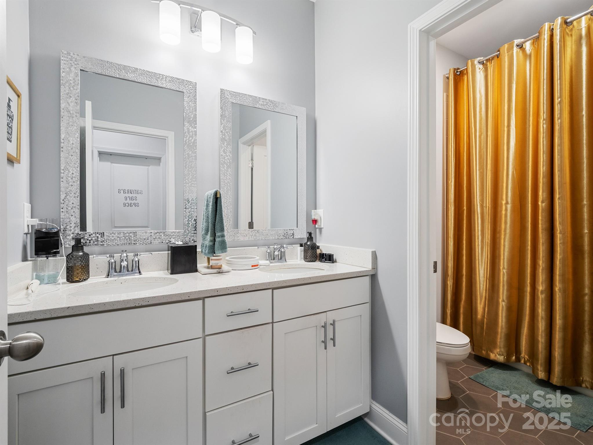15213 Shallow Ridge Road Charlotte, NC 28278 - Photo 36 of 48 a bathroom with a double vanity sink and mirror