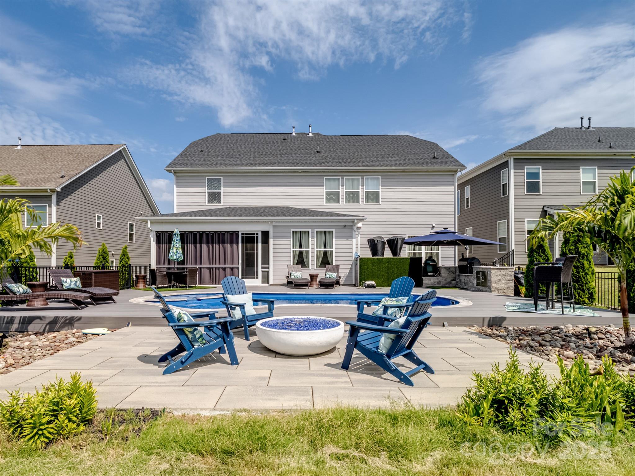 15213 Shallow Ridge Road Charlotte, NC 28278 - Photo 45 of 48 a view of a patio with table and chairs potted plants and a large tree