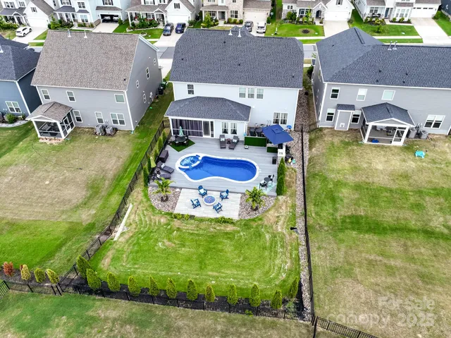 an aerial view of a house with garden space and street view