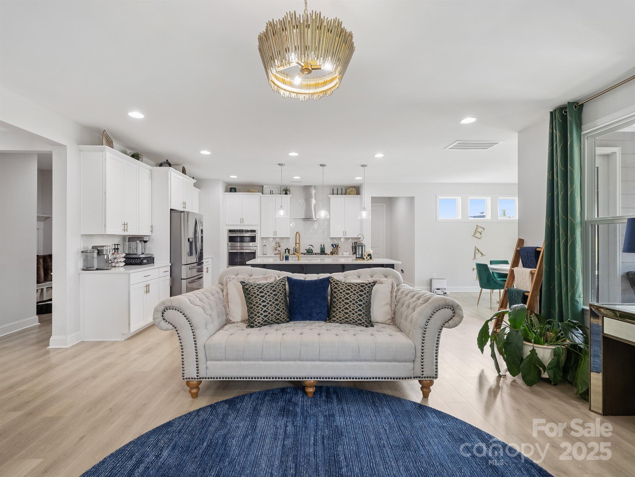 15213 Shallow Ridge Road Charlotte, NC 28278 - Photo 10 of 48 a living room with white couches and kitchen view with wooden floor