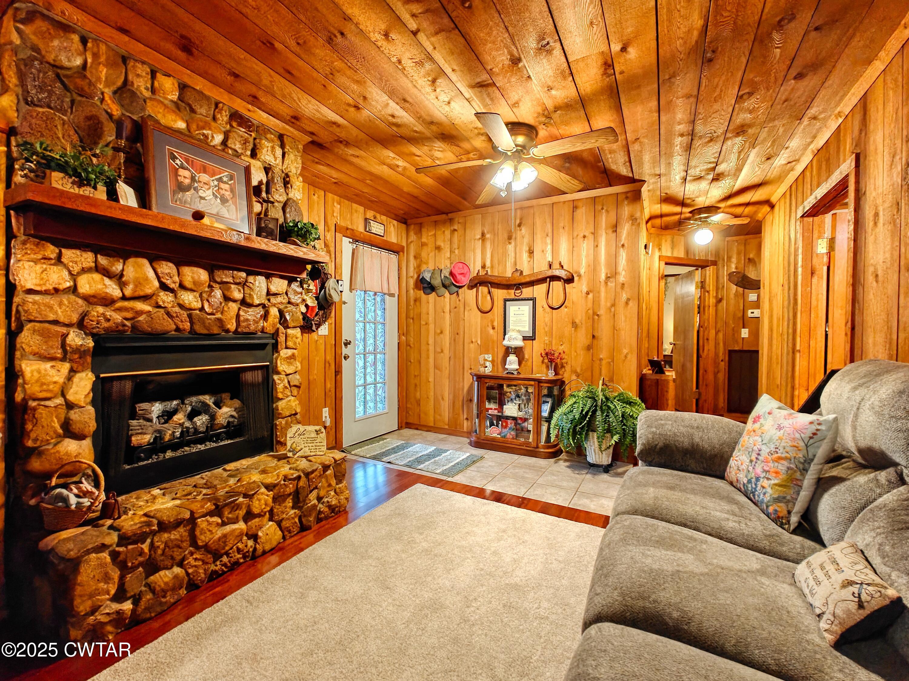 315 Coast Guard Road Buchanan, TN 38222 - Photo 15 of 41 a living room with furniture a fireplace and a flat screen tv