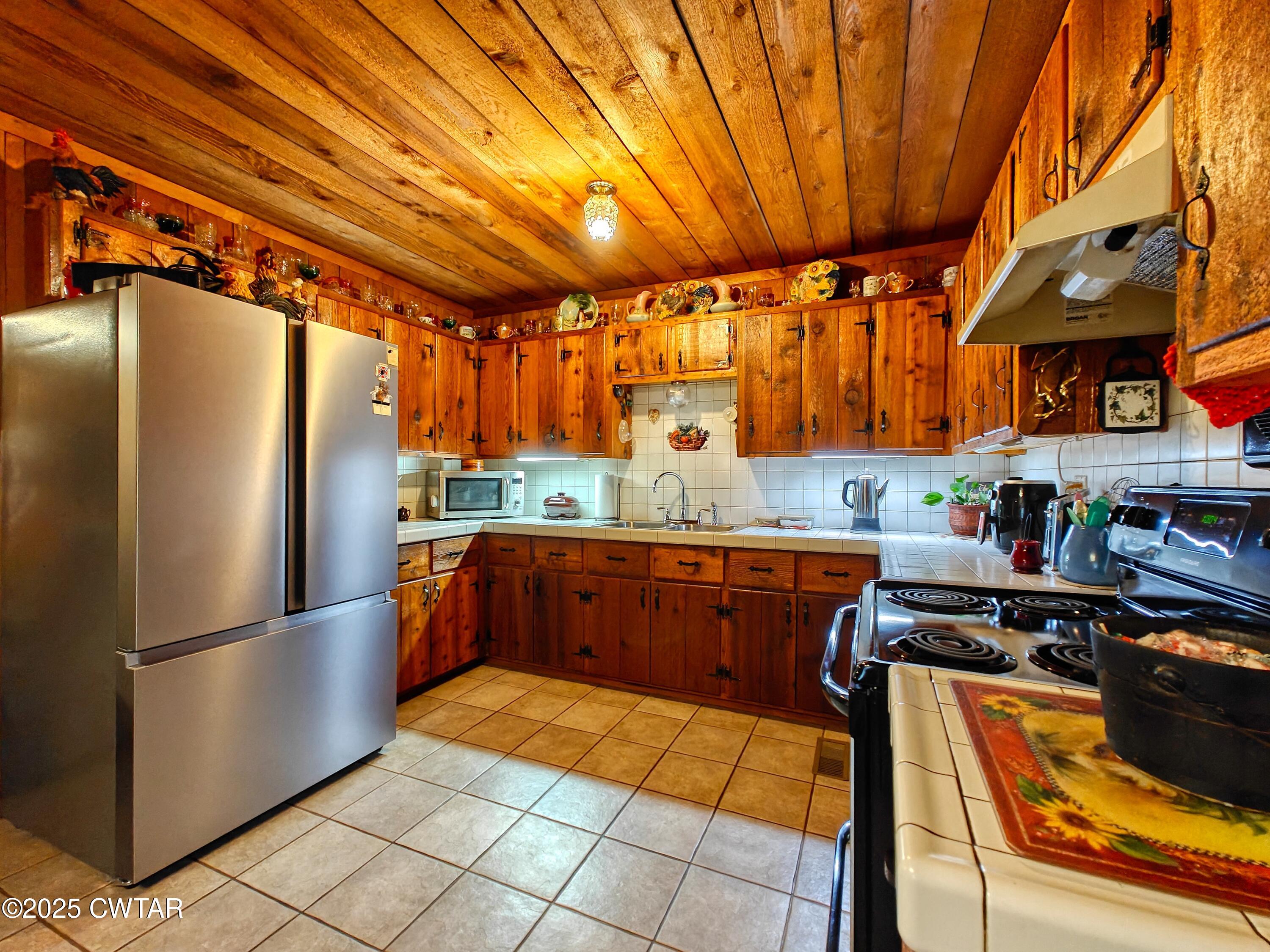 315 Coast Guard Road Buchanan, TN 38222 - Photo 20 of 41 a kitchen with stainless steel appliances granite countertop a refrigerator and a stove top oven