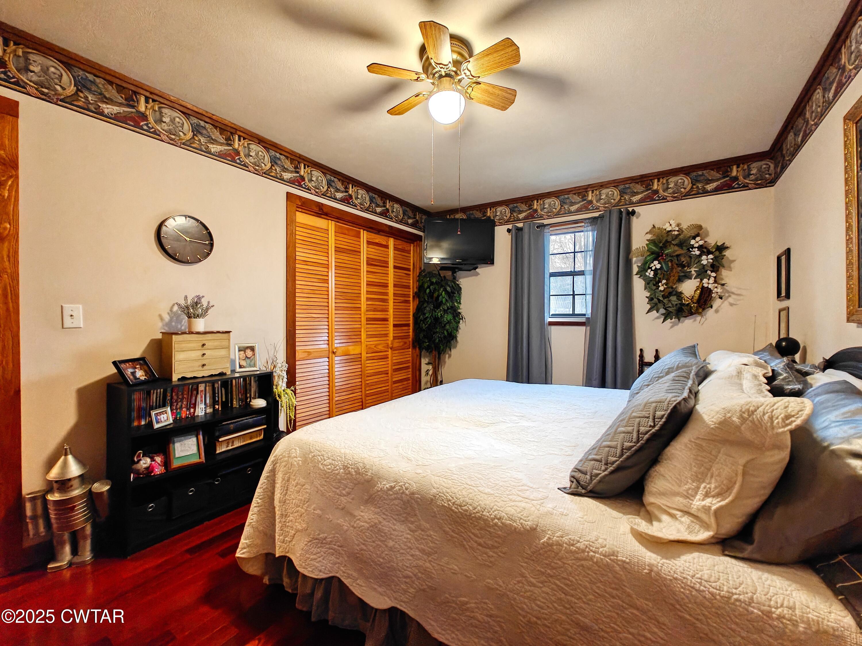 315 Coast Guard Road Buchanan, TN 38222 - Photo 23 of 41 a bed room with a bed and a chandelier