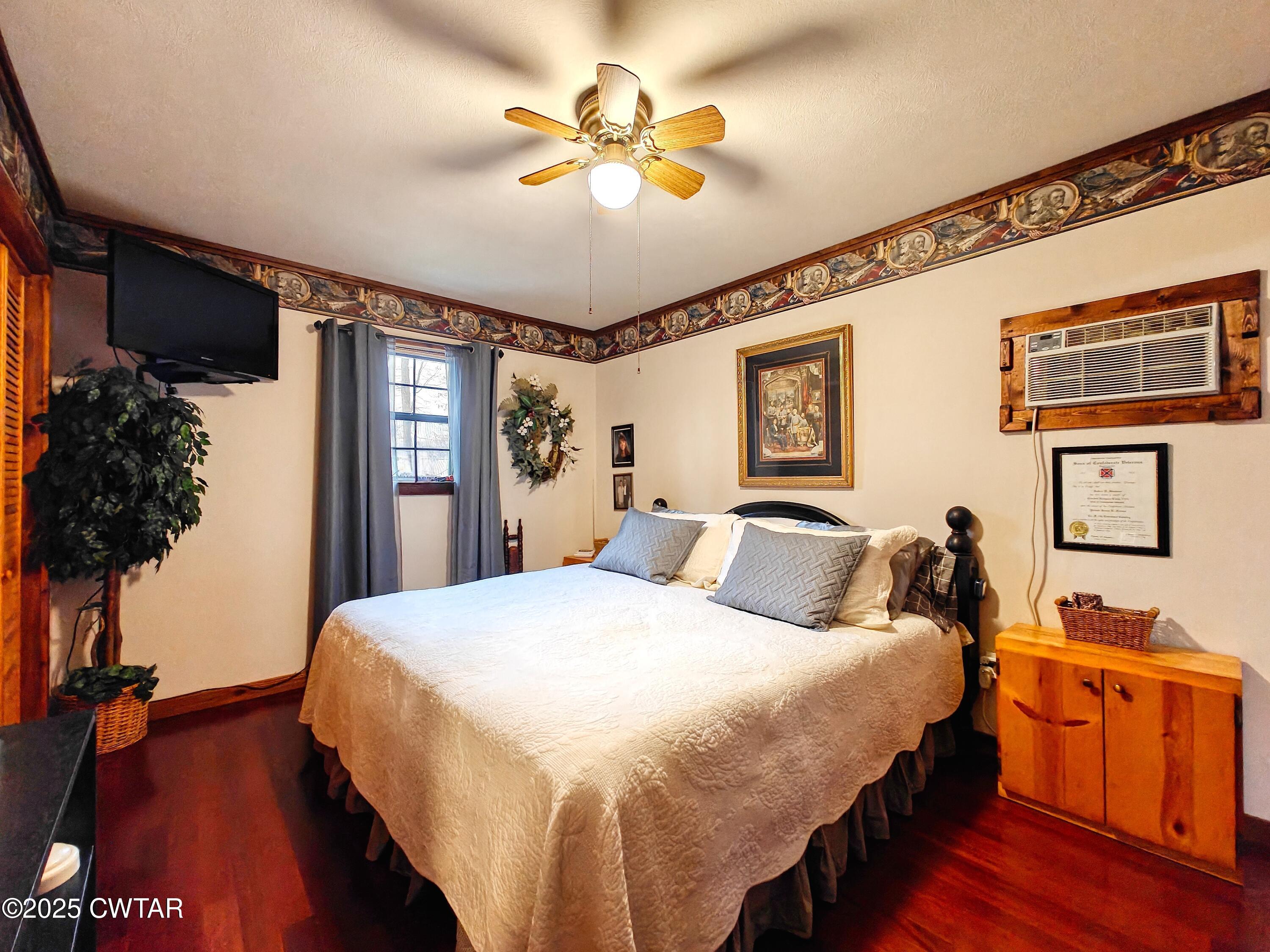 315 Coast Guard Road Buchanan, TN 38222 - Photo 24 of 41 a bed room with a bed and a chandelier