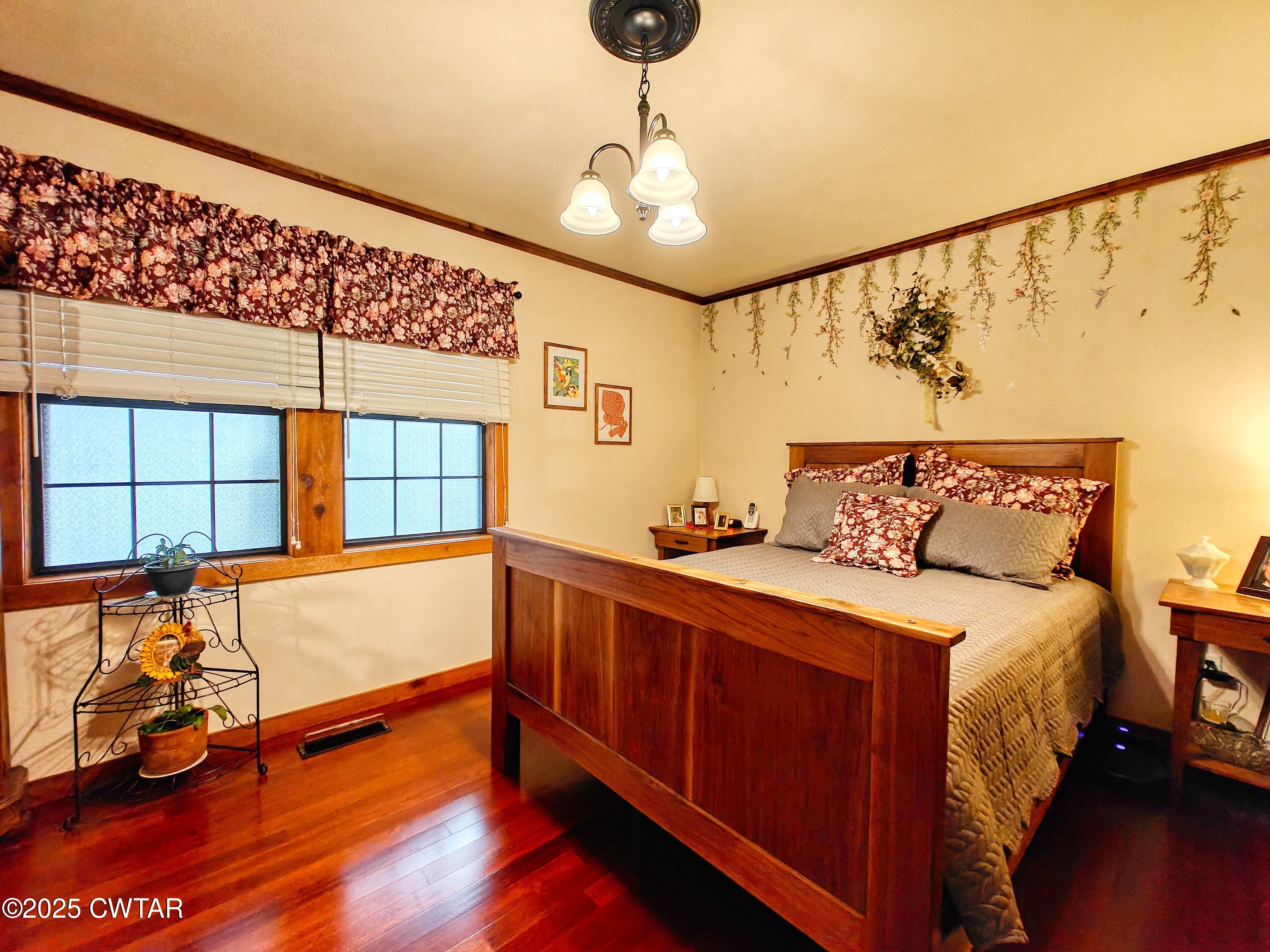 315 Coast Guard Road Buchanan, TN 38222 - Photo 29 of 41 a spacious bedroom with a bed and wooden floor