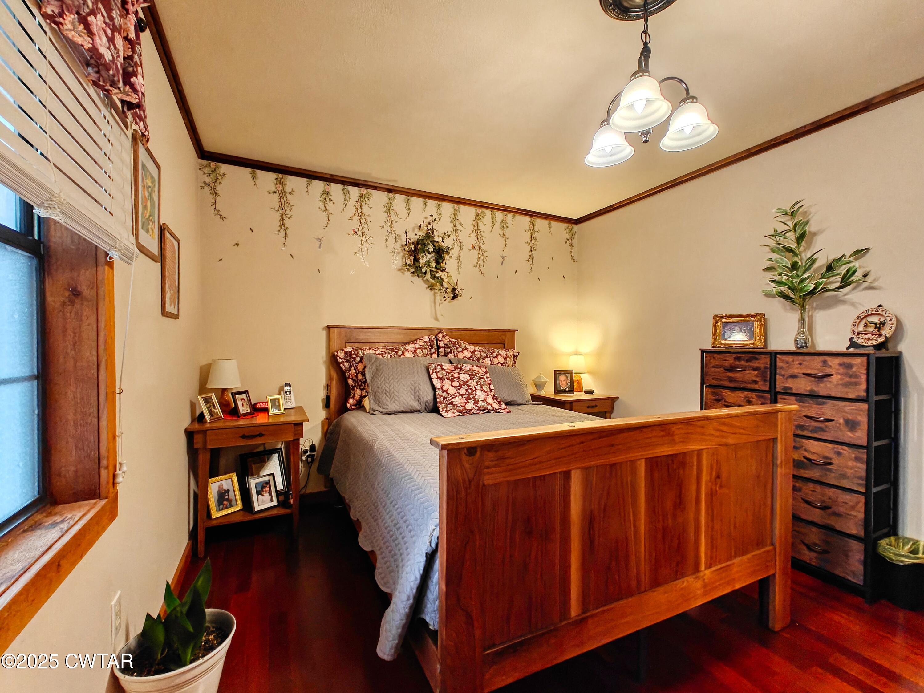 315 Coast Guard Road Buchanan, TN 38222 - Photo 30 of 41 a bedroom with furniture and wooden floor