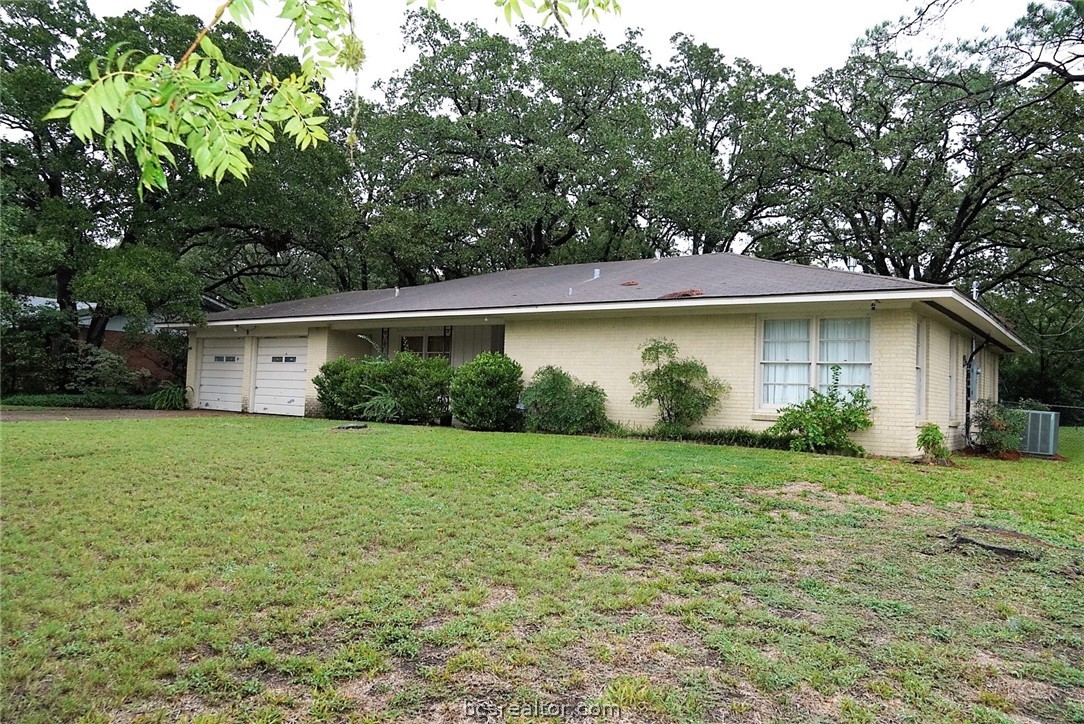 315 Tee Drive Bryan, TX 77801 - Photo 1 of 1 a view of a backyard with plants and large tree