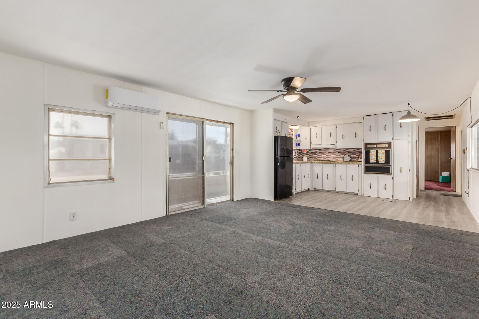 16225 North Cave Creek Road, Unit 1 Phoenix, AZ 85032 - Photo 3 of 33 an empty room with chandelier fan and windows