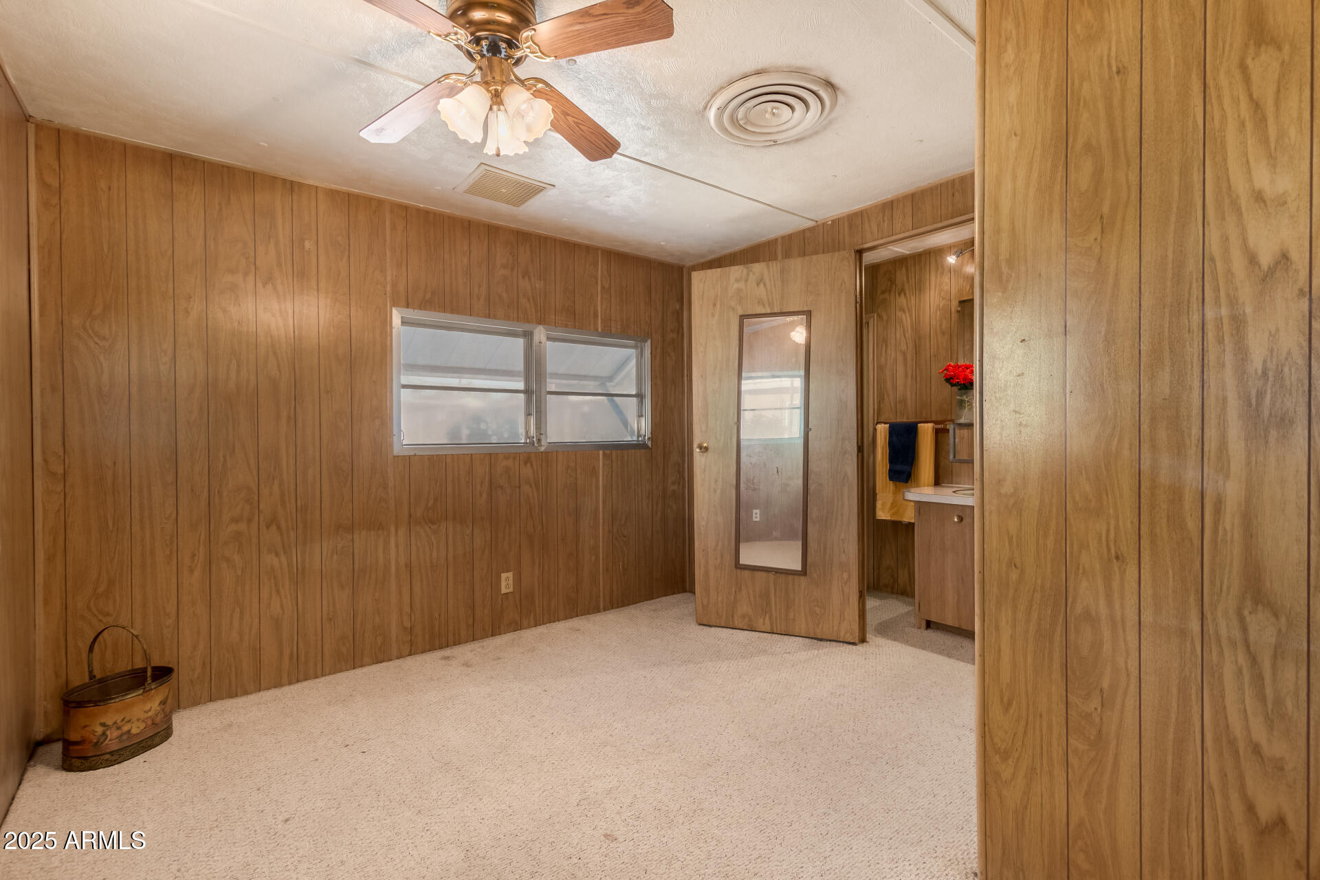 16225 North Cave Creek Road, Unit 1 Phoenix, AZ 85032 - Photo 6 of 33 a bedroom with a bed and a chandelier