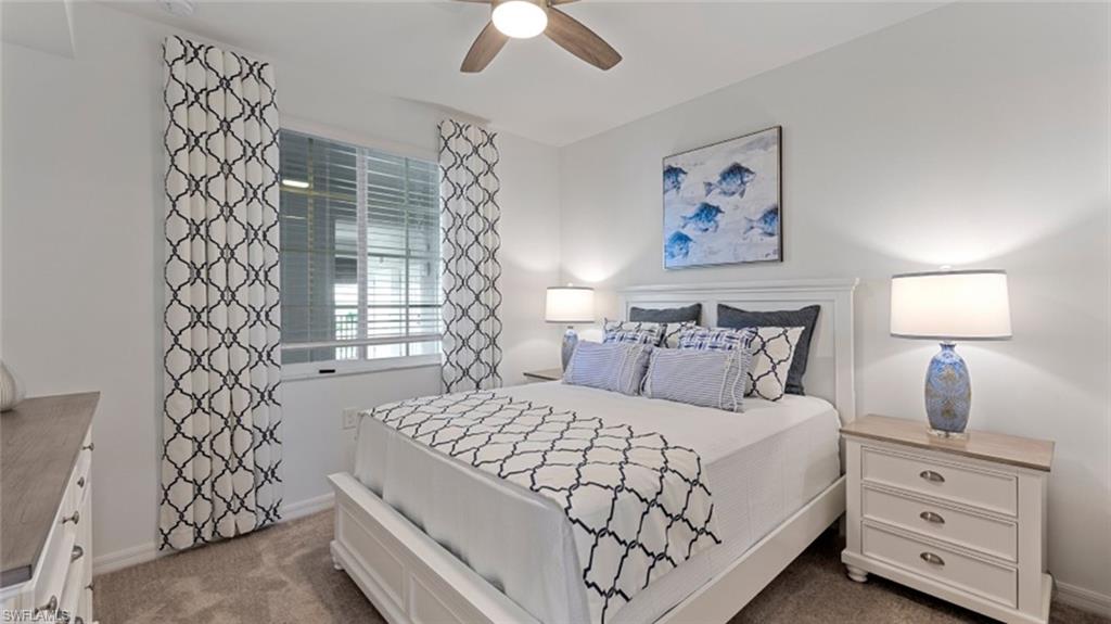 5583 Double Eagle Circle, Unit 4134 Immokalee, FL 34142 - Photo 10 of 32 a bedroom with a bed and a lamp on dresser