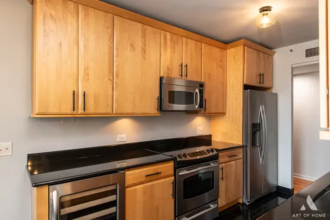 a kitchen with granite countertop a sink and cabinets