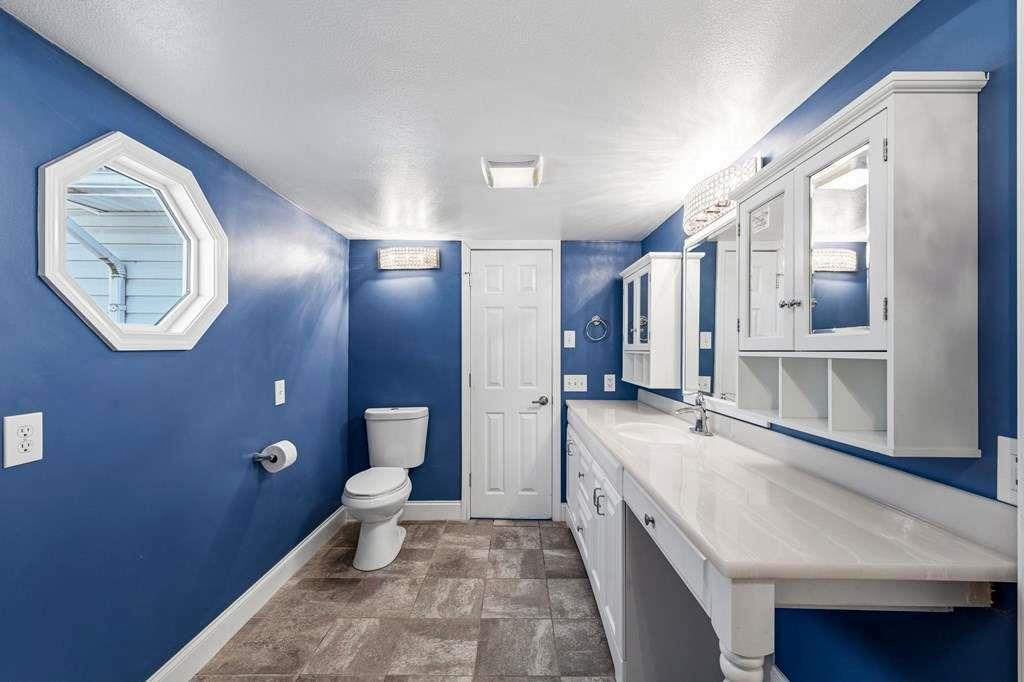 118 Jordan Road Blairsville, GA 30512 - Photo 23 of 49 a spacious bathroom with a granite countertop sink a toilet and a mirror