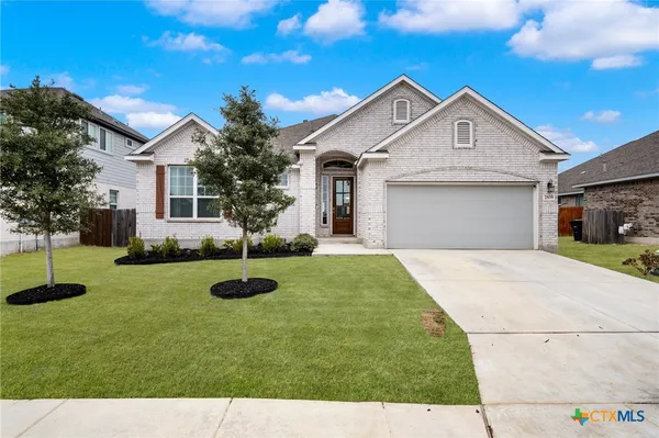 a front view of a house with a yard