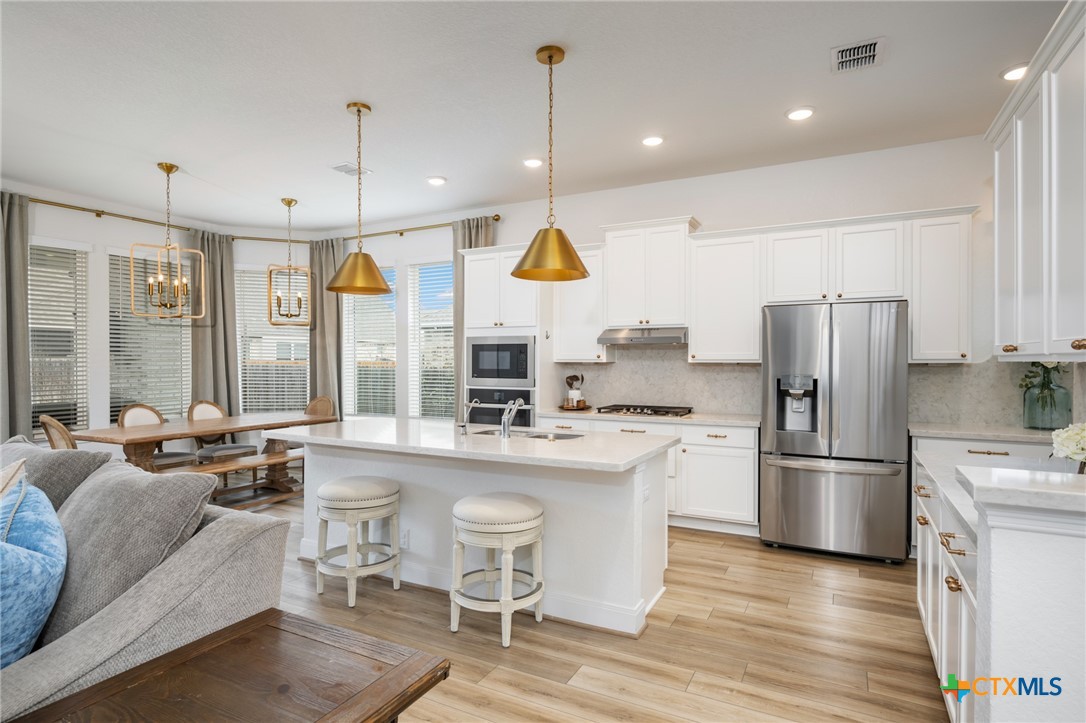 2939 Rems New Braunfels, TX 78130 - Photo 11 of 41 a kitchen with stainless steel appliances granite countertop a sink stove and refrigerator