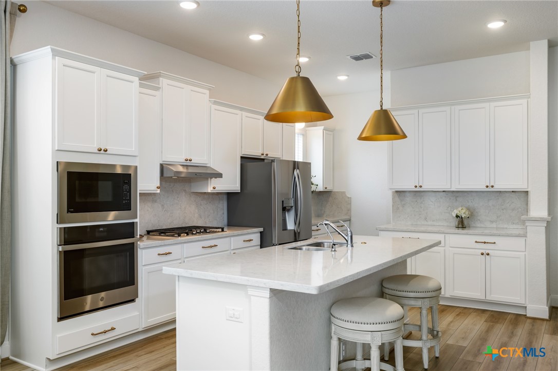 2939 Rems New Braunfels, TX 78130 - Photo 14 of 41 a kitchen with a sink a stove and a refrigerator