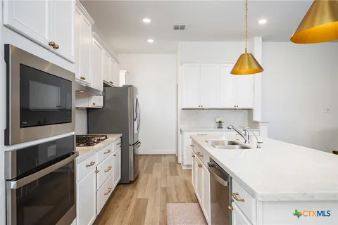 a bathroom with a toilet a sink and a window