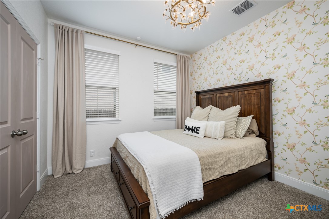 2939 Rems New Braunfels, TX 78130 - Photo 35 of 41 a bedroom with a bed lamp and a window