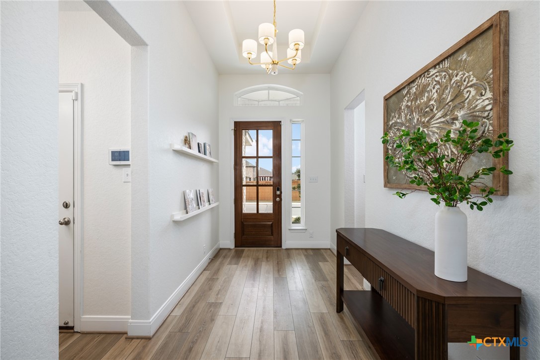 2939 Rems New Braunfels, TX 78130 - Photo 5 of 41 a view of a hallway with wooden floor and staircase