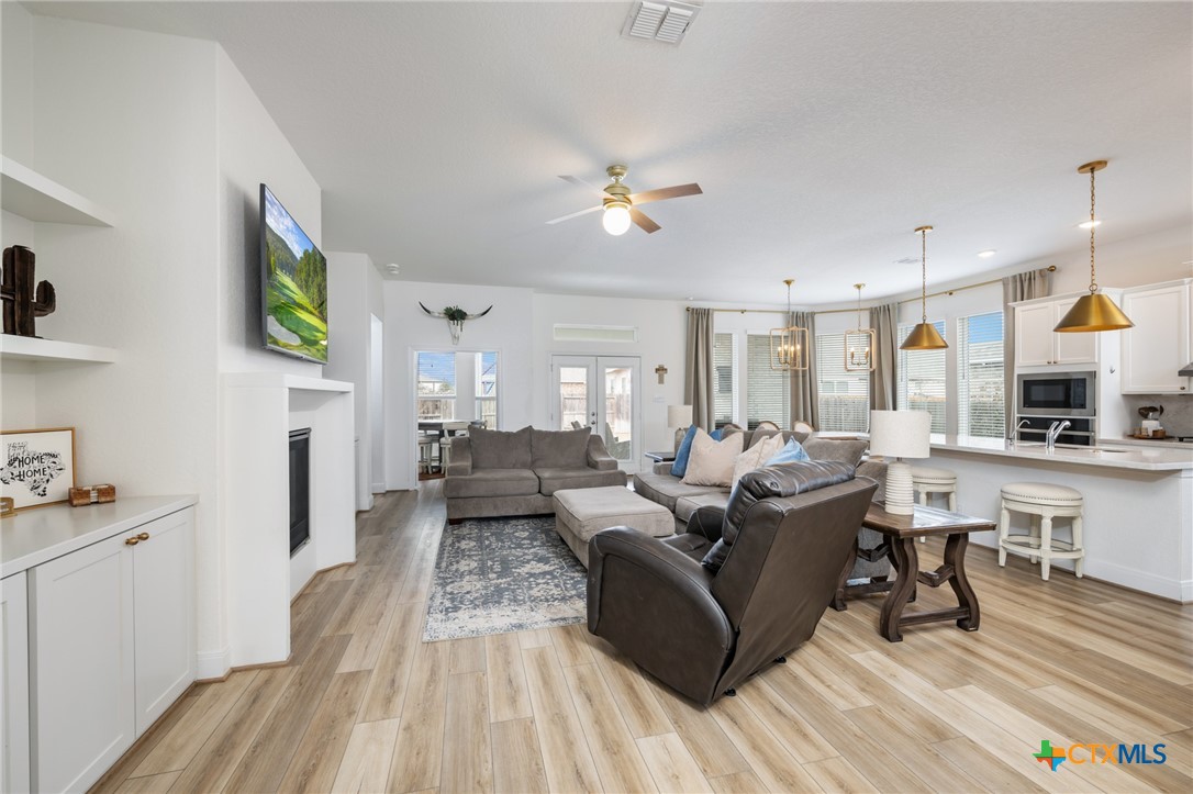 2939 Rems New Braunfels, TX 78130 - Photo 7 of 41 a living room with fireplace furniture and a wooden floor