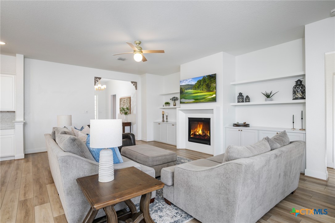 2939 Rems New Braunfels, TX 78130 - Photo 9 of 41 a living room with furniture a flat screen tv and a fireplace