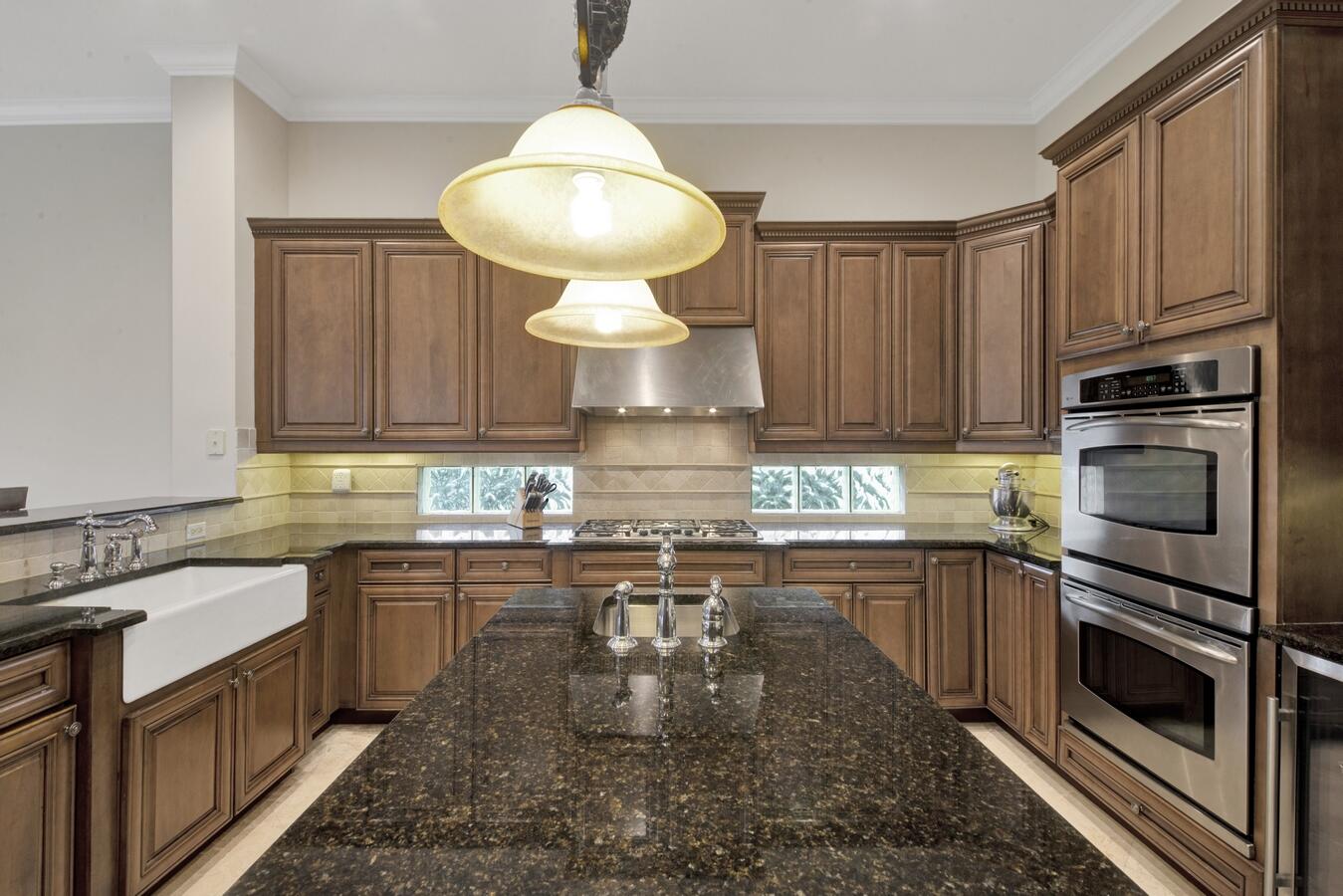 9170 Equus Circle Boynton Beach, FL 33472 - Photo 11 of 71 a kitchen with stainless steel appliances granite countertop a stove sink and cabinets