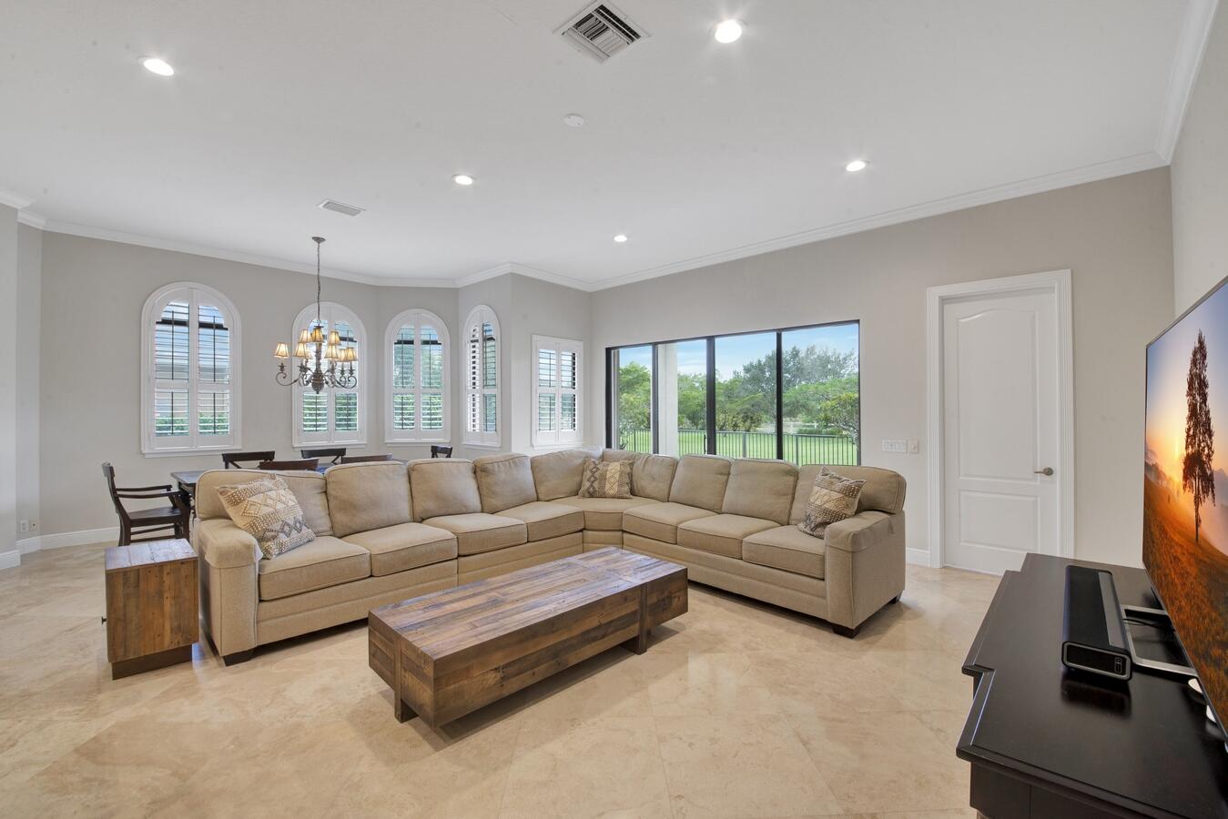 9170 Equus Circle Boynton Beach, FL 33472 - Photo 17 of 71 a living room with furniture flat screen tv and a large window
