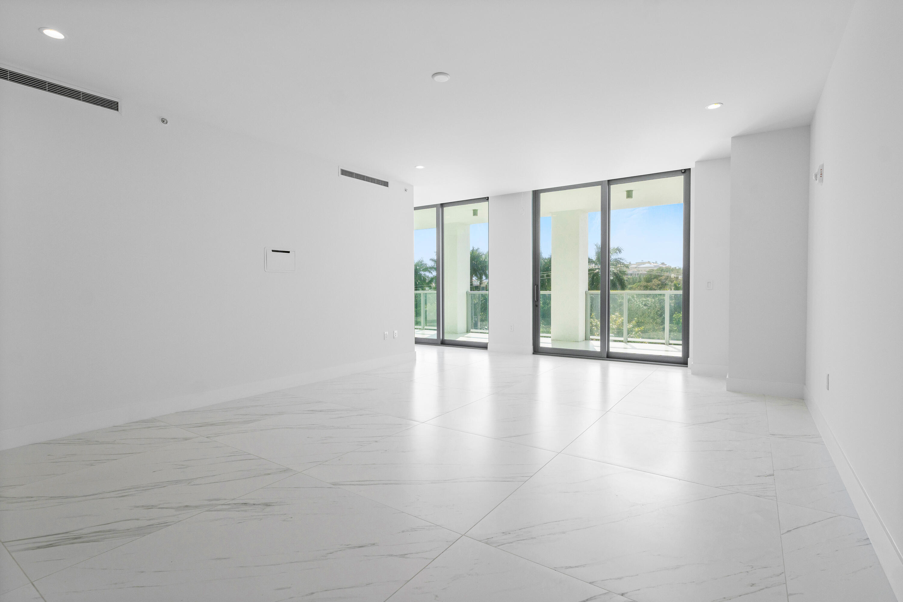 495 East Royal Palm Road, Unit 402 Boca Raton, FL 33432 - Photo 18 of 72 a view of an empty room with wooden floor and a window