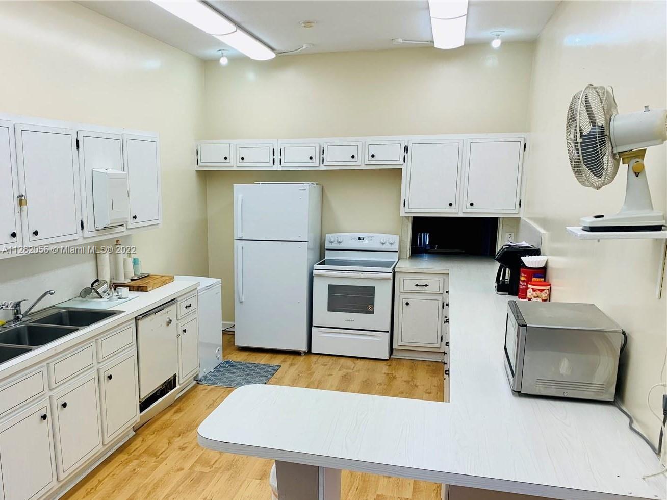 West Perrine Miami, FL 33157 - Photo 23 of 24 a kitchen with a sink a stove and cabinets