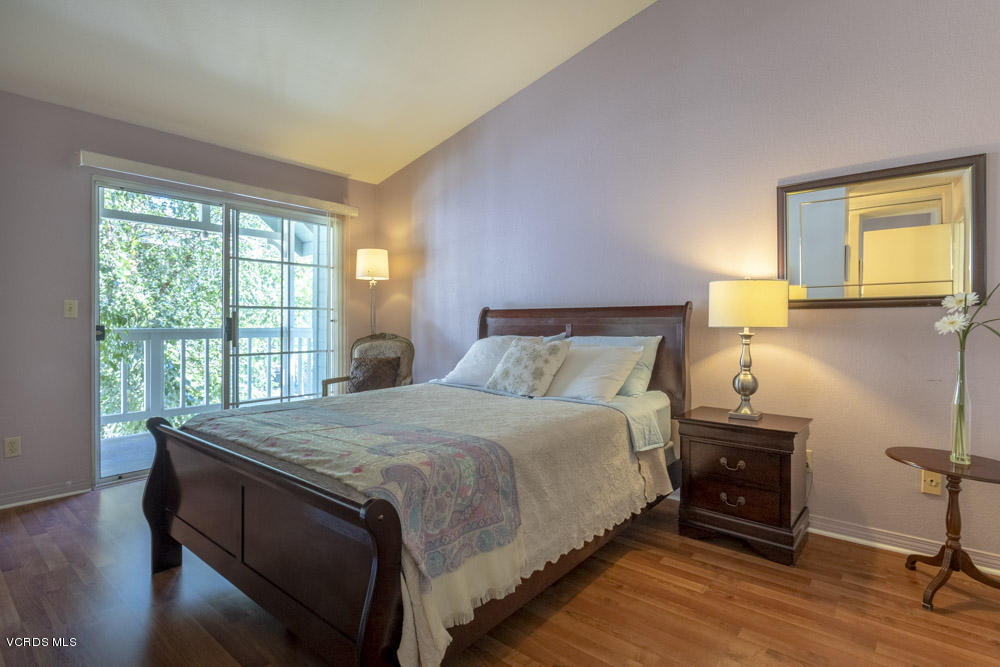 1920 Rory Lane, Unit 4 Simi Valley, CA 93063 - Photo 14 of 24 a bedroom with a bed and wooden floor