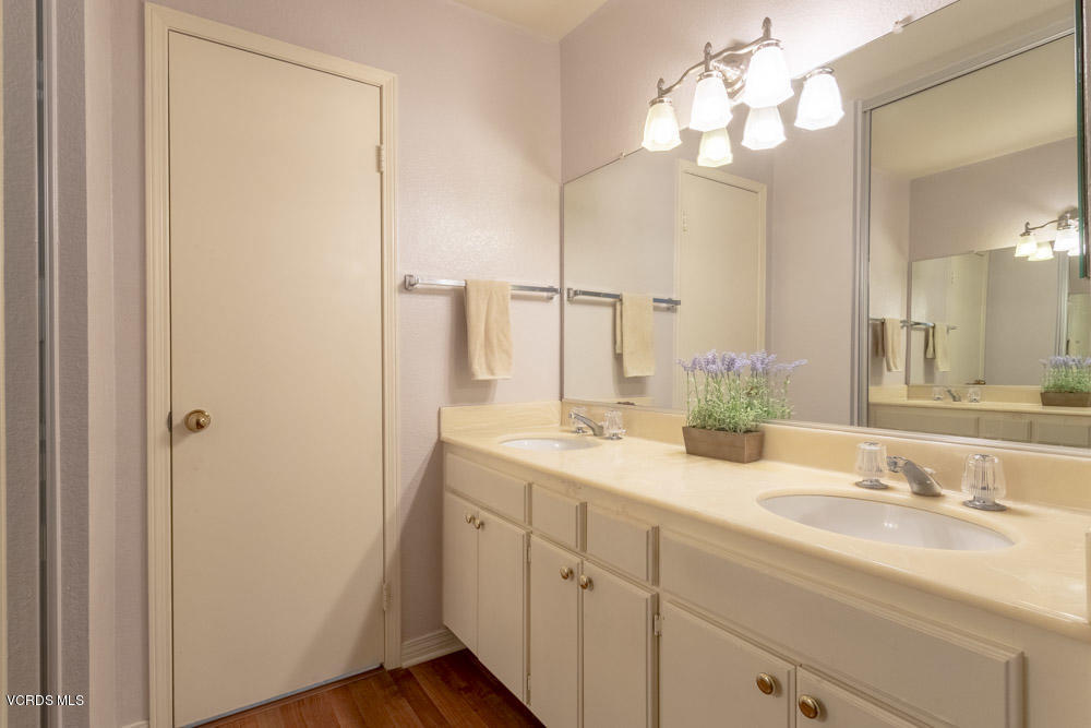 1920 Rory Lane, Unit 4 Simi Valley, CA 93063 - Photo 16 of 24 a bathroom with a double vanity sink and a mirror