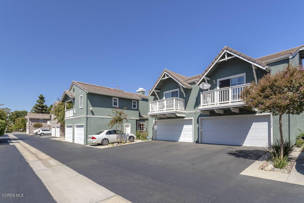 1920 Rory Lane, Unit 4 Simi Valley, CA 93063 - Photo 23 of 24 a front view of a house with a yard and garage