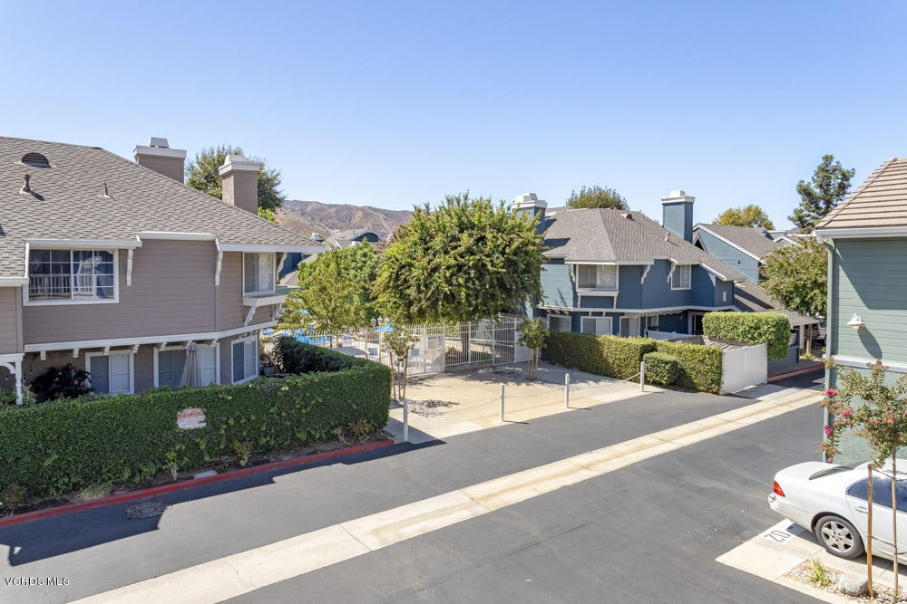 1920 Rory Lane, Unit 4 Simi Valley, CA 93063 - Photo 24 of 24 a front view of a house with a yard and potted plants