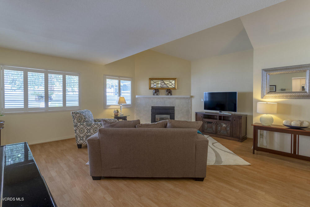 1920 Rory Lane, Unit 4 Simi Valley, CA 93063 - Photo 4 of 24 a living room with furniture a flat screen tv and a fireplace