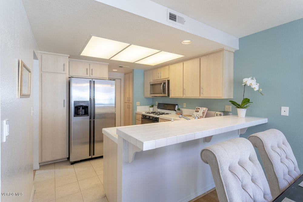 1920 Rory Lane, Unit 4 Simi Valley, CA 93063 - Photo 6 of 24 a kitchen with stainless steel appliances a sink and a refrigerator