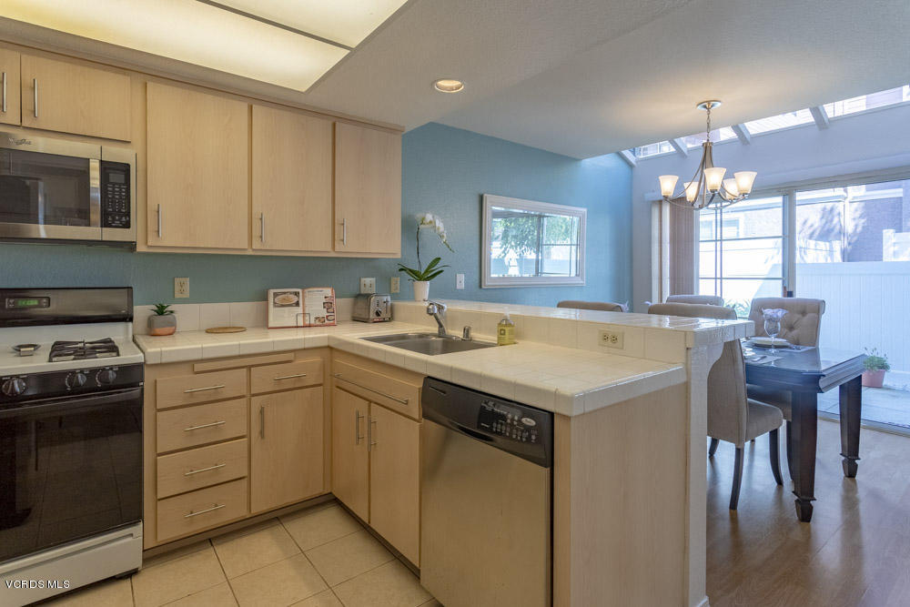 1920 Rory Lane, Unit 4 Simi Valley, CA 93063 - Photo 7 of 24 a kitchen with a sink window and cabinets