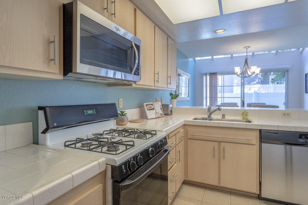 1920 Rory Lane, Unit 4 Simi Valley, CA 93063 - Photo 8 of 24 a kitchen with a stove top oven sink and cabinets