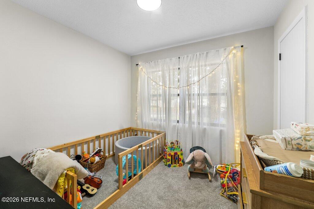 1138 Halifax Road Jacksonville, FL 32216 - Photo 16 of 34 a bedroom with a bed and a window