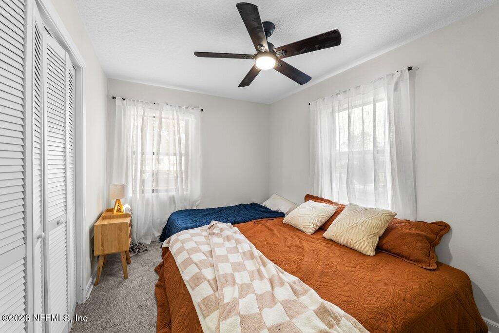 1138 Halifax Road Jacksonville, FL 32216 - Photo 17 of 34 a bedroom with a bed and a large window