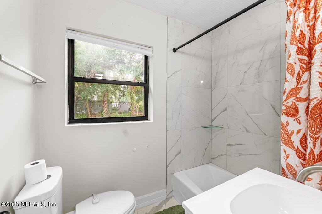 1138 Halifax Road Jacksonville, FL 32216 - Photo 20 of 34 a white toilet sitting next to a bathroom sink