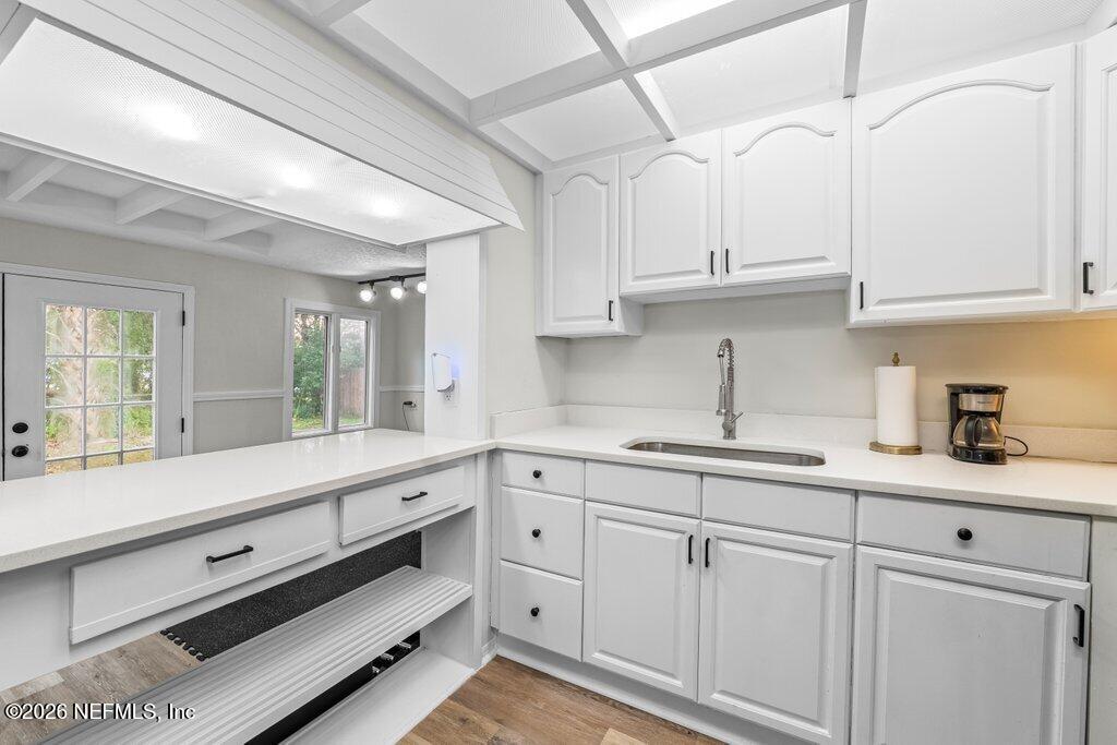 1138 Halifax Road Jacksonville, FL 32216 - Photo 10 of 34 a kitchen with white cabinets and sink
