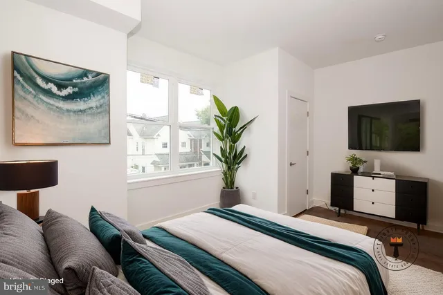 a bedroom with a bed and a flat screen tv